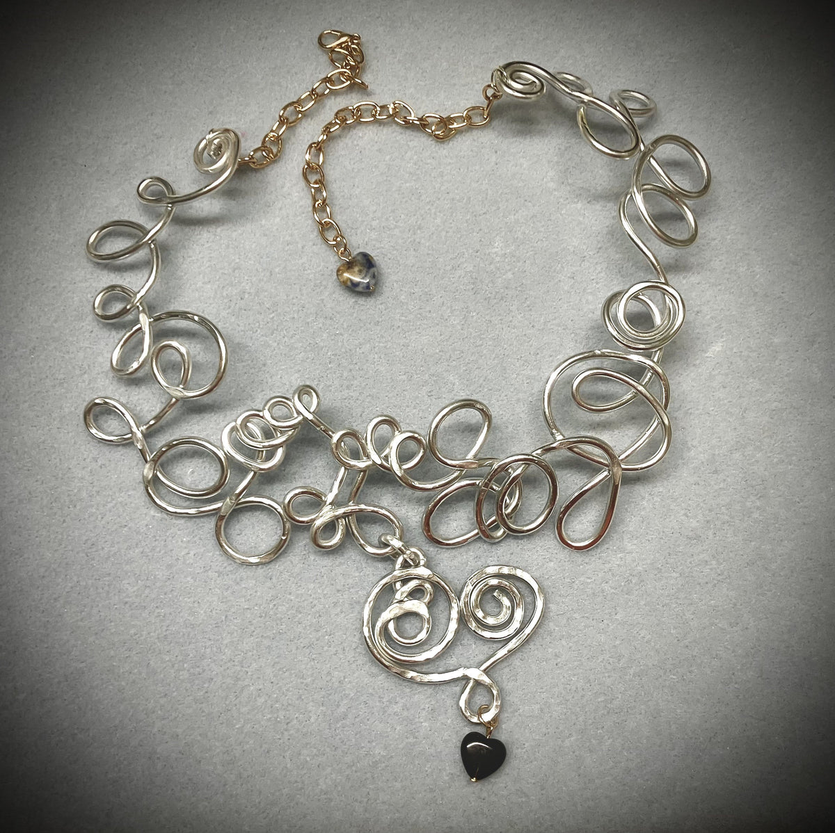 Silver wirework necklace with black heart pendant